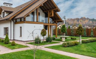 Modern home with healthy landscape with sprinkler system