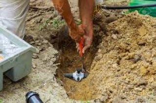 Benafor repairing a broken underground pipe for a sprinkler system